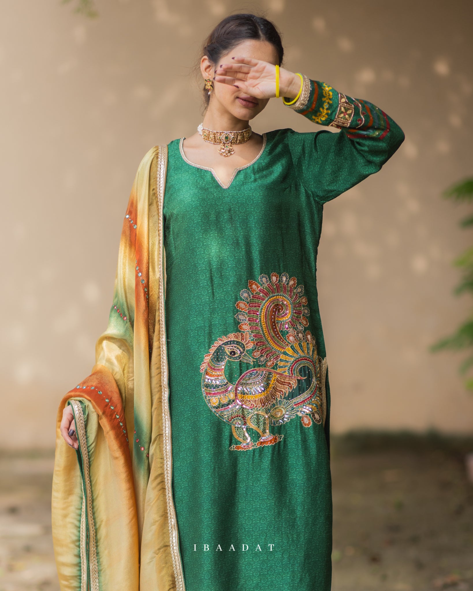 Luxurious dark green silk salwar suit for festive occasions