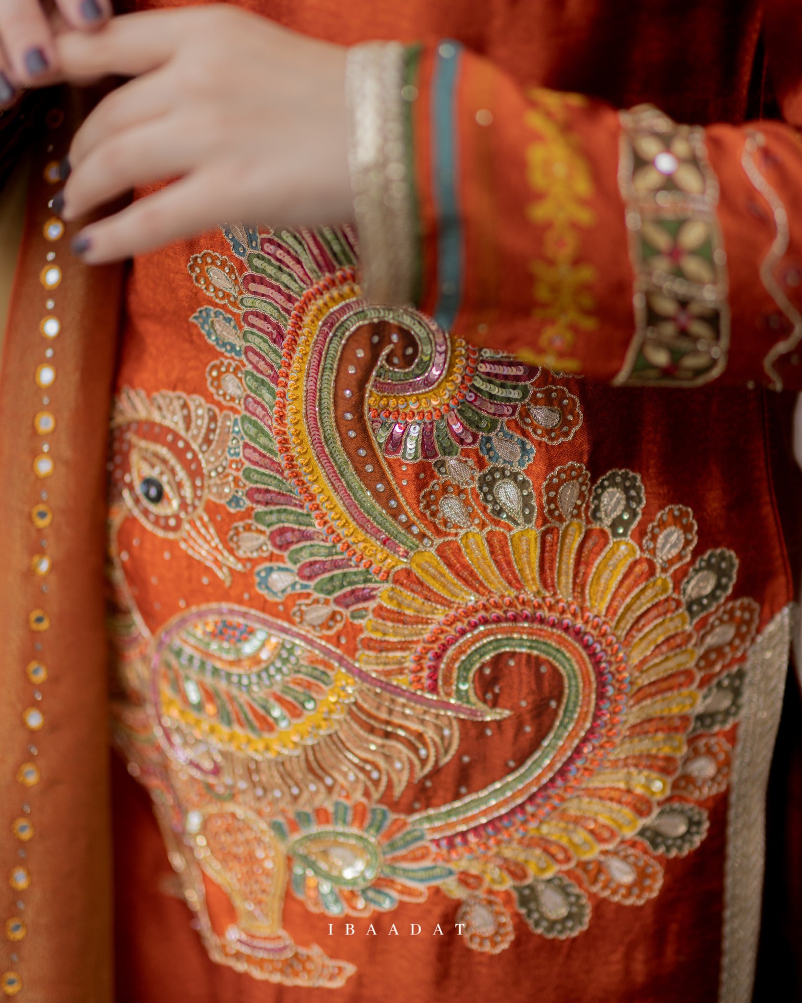 Rust-colored silk salwar suit with intricate hand embroidery