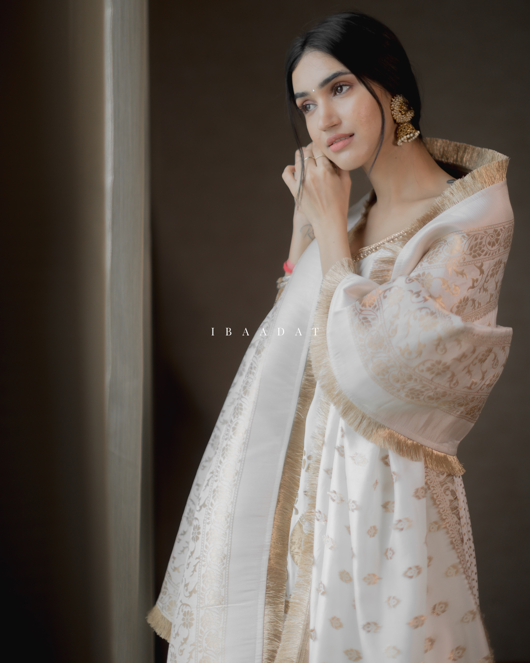 White Punjabi suit with golden print and festive look